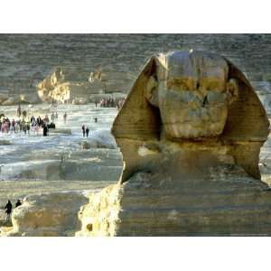Tourists Stroll by Sphinx at the Historical Site of the Giza Pyramids 