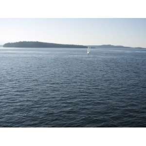 com Sailboat on the Puget Sound Passes Blake Island, Washington State 