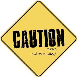   CAUTION  SIMS ON THE WAY  CROSSING SIGN