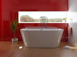 Large porcelain soaking tub in a red bathroom