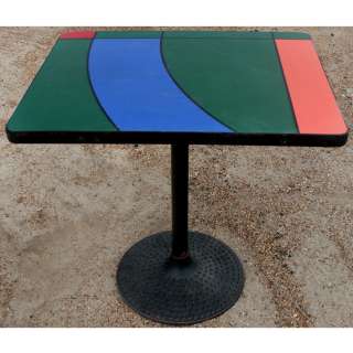  geometric patterns in red blue and green table top has black rubber